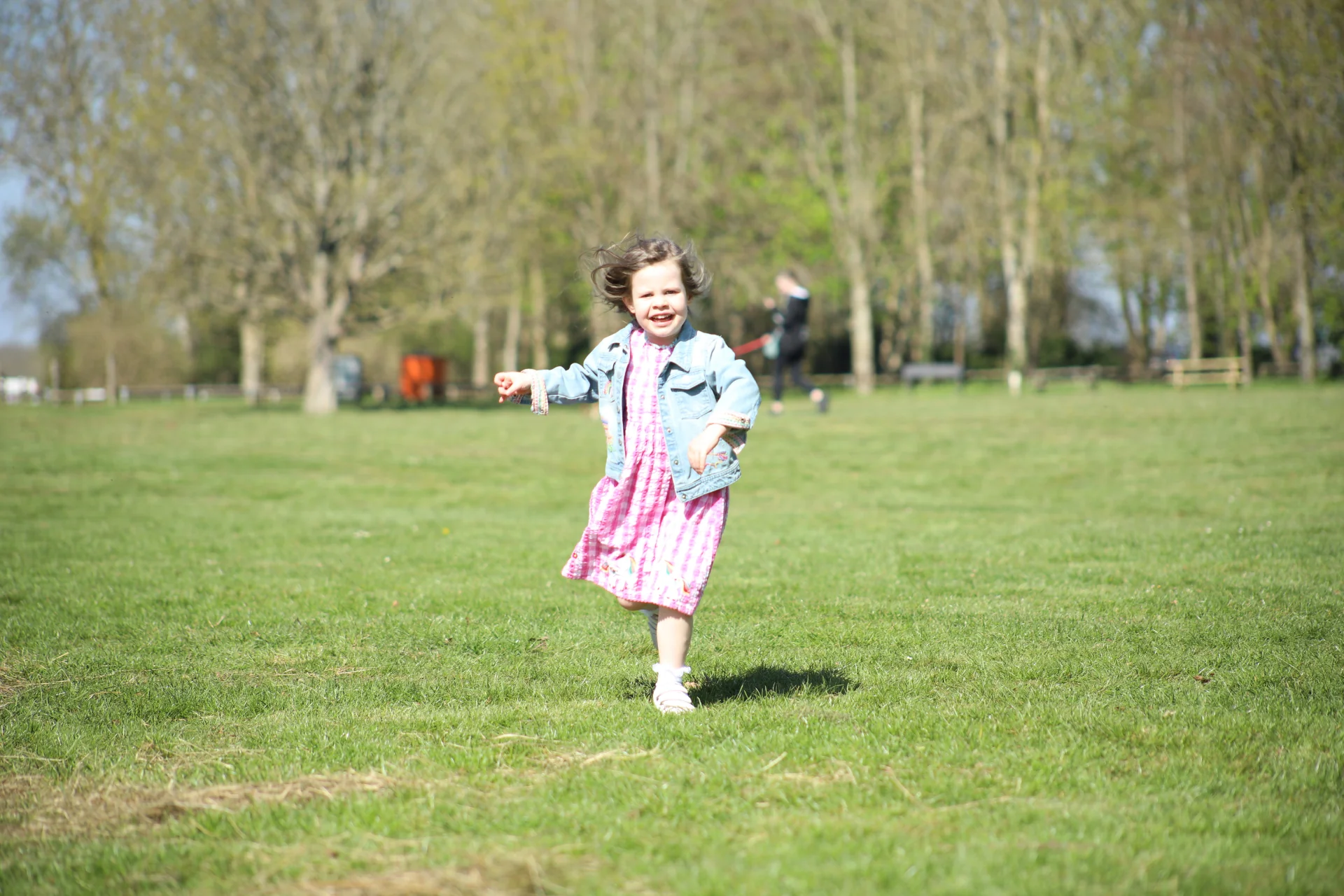 Child running across an open field at Lydiard Park, photographed by Gary Wallage Photography